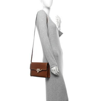 VALENTINO GARAVANI Pebbled Calfskin Medium Rockstud Flip Lock Crossbody Bag Saddle Brown